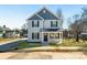 Charming two-story home featuring gray siding, black shutters, and a welcoming front porch at 81 Kirk St, Salisbury, NC 28144