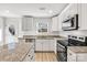 Bright kitchen features white cabinets, stainless steel appliances, and granite countertops at 81 Kirk St, Salisbury, NC 28144