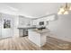 Bright kitchen with white cabinetry, stainless steel appliances, granite countertops, and wood floor at 81 Kirk St, Salisbury, NC 28144