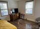 Bedroom featuring wood floors, a large window, and dresser at 827 W Horah St, Salisbury, NC 28144