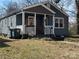 Inviting exterior of a blue home, accented by wood shutters and a covered front porch with white railing at 827 W Horah St, Salisbury, NC 28144