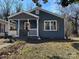 Charming single-story home featuring blue siding, a cozy front porch, and decorative wooden shutters at 827 W Horah St, Salisbury, NC 28144