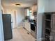 This kitchen has white cabinets, stainless steel appliances, granite countertops and tile floor, perfect for cooking and entertaining at 827 W Horah St, Salisbury, NC 28144
