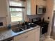 The kitchen features a stainless steel microwave, granite counters, a double sink, and ample light from the window at 827 W Horah St, Salisbury, NC 28144