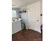 Bright laundry room with a large window, modern washer and dryer, and storage for laundry supplies, making chores easier at 827 W Horah St, Salisbury, NC 28144