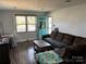 Inviting living room with hardwood floors, neutral walls, a comfortable couch, and natural light at 827 W Horah St, Salisbury, NC 28144