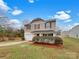 Charming two-story home featuring neutral siding, red shutters and front door, a single car garage and a well-manicured front yard at 845 Finley Rd, Rock Hill, SC 29730