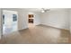 Open-concept living room featuring neutral walls and carpet, with a ceiling fan and views to the kitchen at 845 Finley Rd, Rock Hill, SC 29730