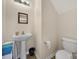 Well-lit half-bath featuring a pedestal sink and toilet at 868 Coach House Ct, Rock Hill, SC 29730