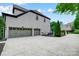 A large two car garage with painted doors and a concrete driveway with a textured finish at 8707 Fairview Rd, Charlotte, NC 28226