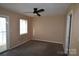 Cozy bedroom with ceiling fan, carpet flooring, and natural light from the window at 9129 Troon Ln # C, Charlotte, NC 28214