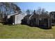 Spacious townhouse with gray siding, balconies, and lawn in a community setting at 9129 Troon Ln # C, Charlotte, NC 28214