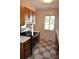 Kitchen with wood cabinets, modern appliances, and checkered tile flooring at 9129 Troon Ln # C, Charlotte, NC 28214