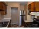Kitchen featuring stainless steel refrigerator, wood cabinets, and modern appliances at 9129 Troon Ln # C, Charlotte, NC 28214