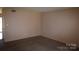 Spacious living room with carpet flooring, neutral colored walls and doorway entrance at 9129 Troon Ln # C, Charlotte, NC 28214