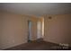 Bright living room with neutral walls, carpet flooring and view to doorway at 9129 Troon Ln # C, Charlotte, NC 28214