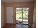 Living room with sliding glass door to brick patio and backyard at 9129 Troon Ln # C, Charlotte, NC 28214