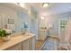 Bathroom featuring double vanities, tile flooring, large mirror and separate shower area at 100 Cliveden Ct, Belmont, NC 28012