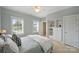 Bright bedroom with multiple windows, a built-in dresser, and neutral color palette at 100 Cliveden Ct, Belmont, NC 28012