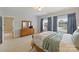 Bedroom featuring natural light, neutral wall color, two windows with curtains, and wood furniture at 100 Cliveden Ct, Belmont, NC 28012