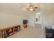Spacious bonus room with built-in bookcases, television, and lots of open space at 100 Cliveden Ct, Belmont, NC 28012