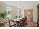 Charming dining room with hardwood floors, traditional furniture, and large arched windows providing natural light at 100 Cliveden Ct, Belmont, NC 28012