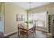Cozy dining room featuring natural light, a wooden table and chairs, and neutral wall colors at 100 Cliveden Ct, Belmont, NC 28012