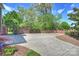 Long driveway leading to a gated entrance, surrounded by mature trees and lush landscaping at 100 Cliveden Ct, Belmont, NC 28012
