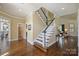 Bright foyer with hardwood floors, a staircase, and doorways leading to various rooms at 100 Cliveden Ct, Belmont, NC 28012
