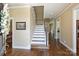 Open foyer with hardwood floors and staircase offers a welcoming entrance and access to the upper levels at 100 Cliveden Ct, Belmont, NC 28012