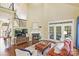 Inviting living room with fireplace, plush seating, and double doors to the outside at 100 Cliveden Ct, Belmont, NC 28012