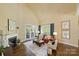 Comfortable living room with a fireplace, large windows, and french doors opening to the outside at 100 Cliveden Ct, Belmont, NC 28012