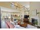 Open-concept living room flows into kitchen and dining area, with a cozy fireplace and plenty of natural light at 100 Cliveden Ct, Belmont, NC 28012
