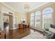 Bright office features hardwood floors, light yellow walls, and abundant natural light from the large windows at 100 Cliveden Ct, Belmont, NC 28012