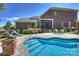 Backyard featuring a uniquely shaped swimming pool, a patio with furniture, and an artful garden at 100 Cliveden Ct, Belmont, NC 28012