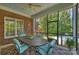 Charming screened porch with brick accents, ceiling fan, and backyard pool view at 100 Cliveden Ct, Belmont, NC 28012