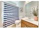 Charming bathroom with a shower-tub combo, patterned shower curtain, and a stylish vanity at 10014 Berkeley Castle Dr, Charlotte, NC 28273