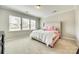 Cozy bedroom with plush carpet, large windows, and a queen-sized bed with patterned linens at 10014 Berkeley Castle Dr, Charlotte, NC 28273