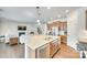 Open-concept kitchen with a large island, stainless steel appliances, and seamless flow to the living area at 10014 Berkeley Castle Dr, Charlotte, NC 28273