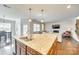Open kitchen featuring a breakfast bar and stainless steel double sink, connecting seamlessly with the living area at 10014 Berkeley Castle Dr, Charlotte, NC 28273