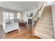Inviting living room featuring hardwood floors, a fireplace, and a staircase, perfect for Gathering gatherings at 10014 Berkeley Castle Dr, Charlotte, NC 28273