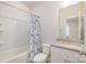 Clean bathroom featuring a tub and shower combination, granite countertops, and modern fixtures, ensuring a refreshing experience at 1006 W B St, Kannapolis, NC 28081
