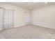 Spacious bedroom with neutral carpet, soft natural light, and ceiling fan, providing a comfortable and airy atmosphere at 1006 W B St, Kannapolis, NC 28081