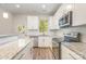 Modern kitchen with white cabinets, granite countertops, and stainless steel appliances at 1006 W B St, Kannapolis, NC 28081
