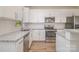 Well-lit kitchen featuring stainless steel appliances, white cabinets, and granite countertops, offering a sleek and modern design at 1006 W B St, Kannapolis, NC 28081