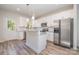 Bright kitchen featuring stainless steel appliances, granite countertops, and white cabinets at 1006 W B St, Kannapolis, NC 28081