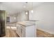 Modern kitchen featuring an island with granite countertops and stainless steel appliances, offering a stylish and functional space at 1006 W B St, Kannapolis, NC 28081