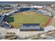 Aerial view of stadium with green grass and a grey building behind the seating area at 108 Oak Grove St, Kannapolis, NC 28081