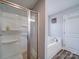 Bright bathroom featuring a bathtub and shower with glass enclosure and a sleek, modern design at 108 Oak Grove St, Kannapolis, NC 28081