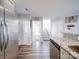 Spacious view from kitchen shows stainless fridge, wood floors, and open floor plan with staircase at 108 Oak Grove St, Kannapolis, NC 28081